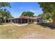Rear exterior showcasing the screened porch offering an ideal spot for relaxation and entertainment at 3240 Flamingo Ln, Mulberry, FL 33860