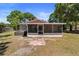 Rear exterior with a screened porch and jacuzzi, an ideal spot for relaxation and entertainment at 3240 Flamingo Ln, Mulberry, FL 33860