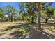 Spacious, tree-filled backyard with mature trees creating a tranquil, shaded outdoor space at 3240 Flamingo Ln, Mulberry, FL 33860