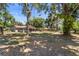 Expansive backyard featuring a screened-in porch and mature trees offering shade and privacy at 3240 Flamingo Ln, Mulberry, FL 33860