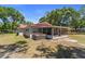 Backyard showcasing the screened porch with hot tub, offering an ideal spot for relaxation at 3240 Flamingo Ln, Mulberry, FL 33860