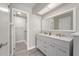 Bathroom featuring dual sinks, gray cabinets, and a large framed mirror at 3240 Flamingo Ln, Mulberry, FL 33860
