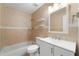 Tiled bathroom featuring a shower-tub combo and a white vanity with ample counter space at 3240 Flamingo Ln, Mulberry, FL 33860