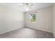 Carpeted bedroom features a ceiling fan and one window at 3240 Flamingo Ln, Mulberry, FL 33860