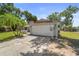 Exterior view of the garage and home, showcasing its curb appeal and red roof at 3240 Flamingo Ln, Mulberry, FL 33860