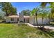 A picturesque single-Gathering home with a red roof, manicured lawn, and convenient attached garage at 3240 Flamingo Ln, Mulberry, FL 33860