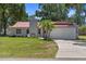 Charming single-story home boasts a red roof, two-car garage, and well-manicured front lawn at 3240 Flamingo Ln, Mulberry, FL 33860