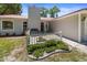 Close up of front yard with walkway to entry and a garden with a white fence at 3240 Flamingo Ln, Mulberry, FL 33860