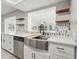 Updated kitchen featuring stainless steel sink, dishwasher and decorative backsplash at 3240 Flamingo Ln, Mulberry, FL 33860