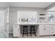 Kitchen bar with white cabinets and two stools, open to the living area at 3240 Flamingo Ln, Mulberry, FL 33860