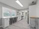 Modern kitchen with bar seating, white cabinets, and stainless steel appliances at 3240 Flamingo Ln, Mulberry, FL 33860