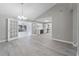 Open living room featuring new flooring, and a smooth transition to the kitchen and sun room at 3240 Flamingo Ln, Mulberry, FL 33860