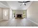 Bright and open living area featuring a cozy stone fireplace, new floors, and backyard views at 3240 Flamingo Ln, Mulberry, FL 33860