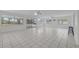 Bright living room with tile flooring, multiple windows, and access to an outdoor patio at 3240 Flamingo Ln, Mulberry, FL 33860