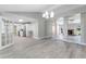 Open-concept living room and kitchen featuring light gray flooring and contemporary design elements at 3240 Flamingo Ln, Mulberry, FL 33860