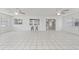 Open living room has tile flooring and a pass-through window to the kitchen at 3240 Flamingo Ln, Mulberry, FL 33860