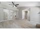 Spacious living room offering new flooring, ceiling fan, and clear sight lines to adjacent spaces at 3240 Flamingo Ln, Mulberry, FL 33860