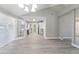 An open concept dining and kitchen area with modern flooring and stainless steel appliances at 3240 Flamingo Ln, Mulberry, FL 33860