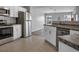 Open concept kitchen with stainless steel appliances and white cabinets at 518 Marion Oaks Trl, Ocala, FL 34473
