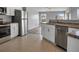 Open concept kitchen with stainless steel appliances and white cabinets at 518 Marion Oaks Trl, Ocala, FL 34473