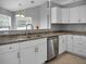 Modern kitchen with white cabinets, stainless steel appliances, and granite countertops at 518 Marion Oaks Trl, Ocala, FL 34473