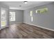 Bright living room featuring vinyl plank flooring and multiple windows at 518 Marion Oaks Trl, Ocala, FL 34473