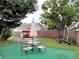 Large backyard with patio furniture, putting green, and basketball hoop at 11432 Cardiff Dr, Orlando, FL 32837