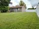 Large grassy backyard with basketball hoop at 11432 Cardiff Dr, Orlando, FL 32837