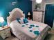 Main bedroom with teal walls and dresser at 11432 Cardiff Dr, Orlando, FL 32837