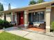 Red front door, porch with seating, and walkway at 11432 Cardiff Dr, Orlando, FL 32837