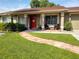 Red front door, walkway, and porch with seating at 11432 Cardiff Dr, Orlando, FL 32837