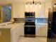 Updated kitchen with white cabinets and stainless steel appliances at 11432 Cardiff Dr, Orlando, FL 32837