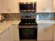 Stainless steel range and microwave in updated kitchen at 11432 Cardiff Dr, Orlando, FL 32837