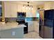 Modern kitchen with white cabinets, stainless steel appliances, and quartz countertops at 11432 Cardiff Dr, Orlando, FL 32837