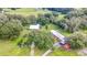 Aerial view of the property showcasing the log cabin home and surrounding pastures at 4292 Sw 73Rd Trl, Bushnell, FL 33513