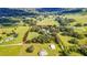 Expansive aerial view of the property, showing the large acreage with trees, green fields, and outlined property lines at 4292 Sw 73Rd Trl, Bushnell, FL 33513