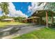 Equestrian property featuring barn with horse trailer parking and lush green surroundings under a bright blue sky at 4292 Sw 73Rd Trl, Bushnell, FL 33513