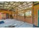 Barn interior featuring a spacious stall with wooden walls, ceiling fan, and secure windows for horses at 4292 Sw 73Rd Trl, Bushnell, FL 33513
