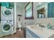 Cozy bathroom featuring a stacked washer/dryer unit for space-saving convenience at 4292 Sw 73Rd Trl, Bushnell, FL 33513
