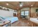 Comfortable bedroom with wood ceilings, wooden floors, and a ceiling fan at 4292 Sw 73Rd Trl, Bushnell, FL 33513