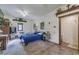 Simple bedroom with ceiling fan, side table, and doorway to bathroom at 4292 Sw 73Rd Trl, Bushnell, FL 33513