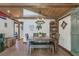 Charming dining room featuring wooden accents, a stylish light fixture, and an adjacent barn door detail at 4292 Sw 73Rd Trl, Bushnell, FL 33513