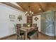 Cozy dining area with a wooden table and seating, complemented by rustic décor and a barn door detail at 4292 Sw 73Rd Trl, Bushnell, FL 33513