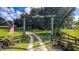 Charming ranch entrance with a wooden 'Welcome to the Ranch' sign, flanked by an American flag and gated fence at 4292 Sw 73Rd Trl, Bushnell, FL 33513
