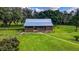Charming exterior view of a log cabin home with a well-maintained lawn at 4292 Sw 73Rd Trl, Bushnell, FL 33513