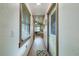 Hallway with wood accents throughout, a window, and access to other rooms at 4292 Sw 73Rd Trl, Bushnell, FL 33513