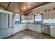 Spacious kitchen featuring a stainless steel refrigerator, light colored cabinetry, and wood flooring at 4292 Sw 73Rd Trl, Bushnell, FL 33513