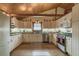 Charming kitchen with white cabinets, granite countertops, stainless steel appliances, and a wood paneled ceiling at 4292 Sw 73Rd Trl, Bushnell, FL 33513