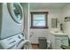 Cozy laundry room with stacked washer and dryer, and a framed window at 4292 Sw 73Rd Trl, Bushnell, FL 33513