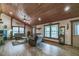 Bright and airy living room boasting a wooden ceiling, comfortable furniture, and natural light from multiple windows at 4292 Sw 73Rd Trl, Bushnell, FL 33513